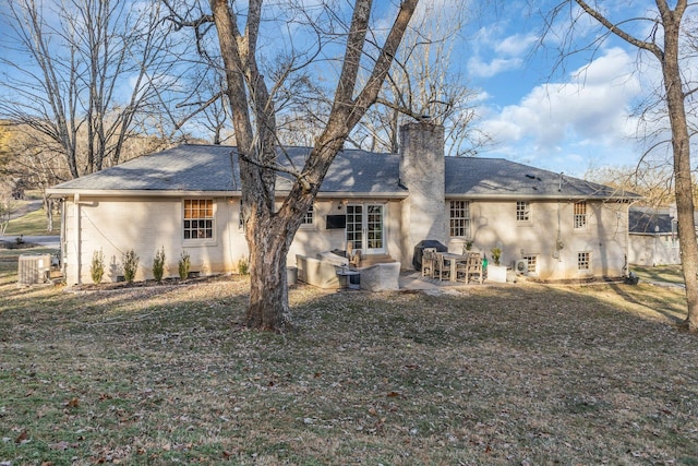 back of house with a patio area and a lawn