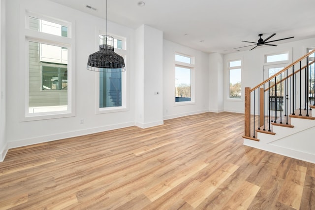 unfurnished living room featuring ceiling fan and light hardwood / wood-style flooring