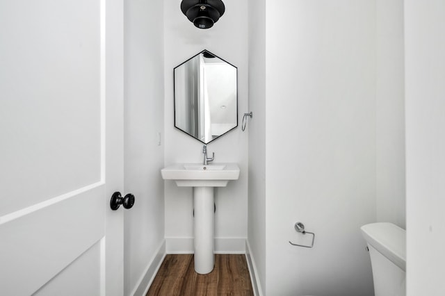 bathroom featuring hardwood / wood-style floors and toilet