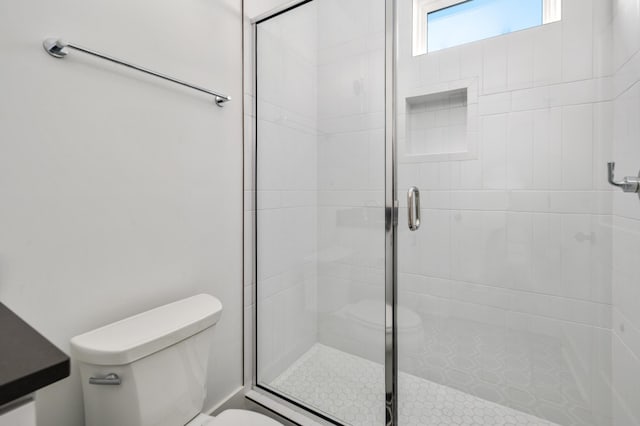 bathroom with toilet and walk in shower