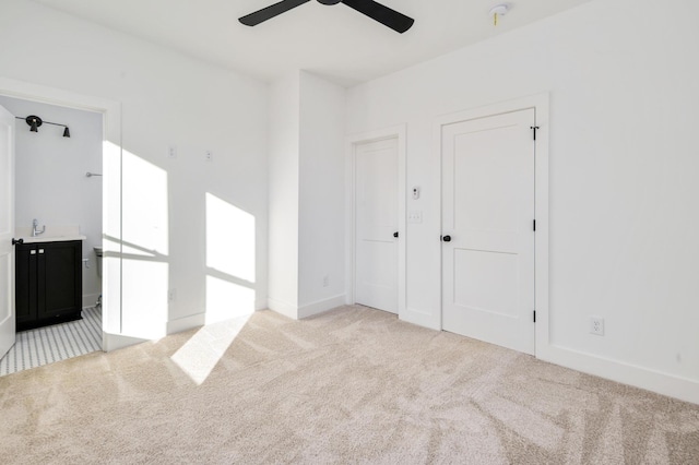 spare room with light colored carpet and ceiling fan