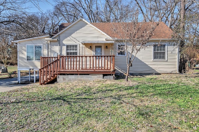 view of front of home with a wooden deck and a front yard