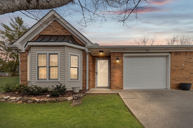 view of front facade featuring a garage and a lawn