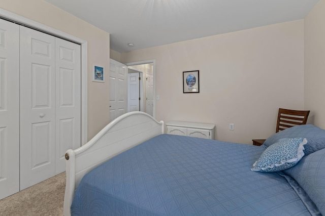 bedroom featuring light colored carpet and a closet