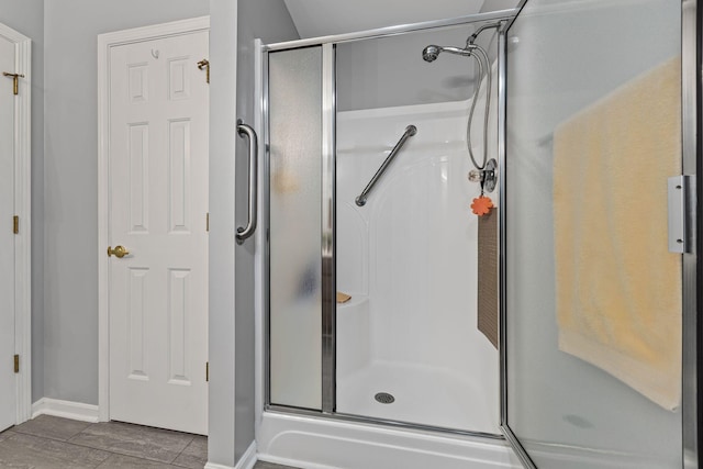 bathroom featuring tile patterned floors and a shower with shower door