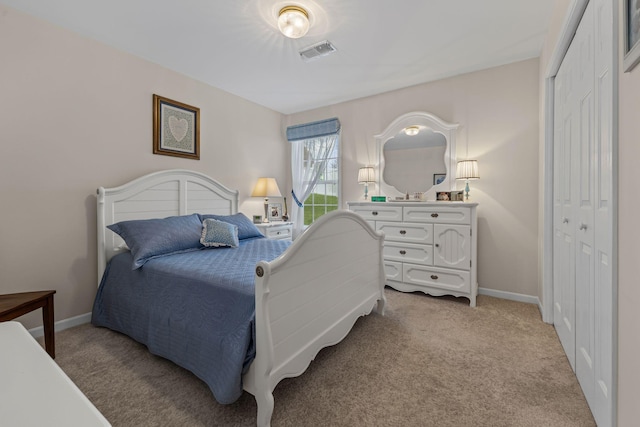 bedroom with light carpet and a closet