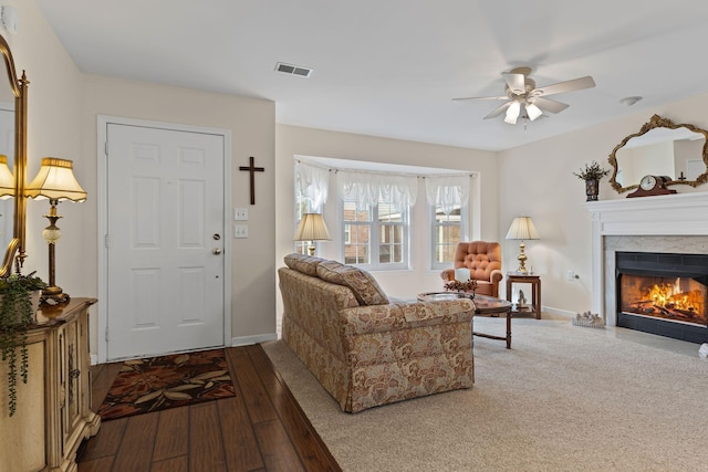 living room featuring hardwood / wood-style floors and ceiling fan