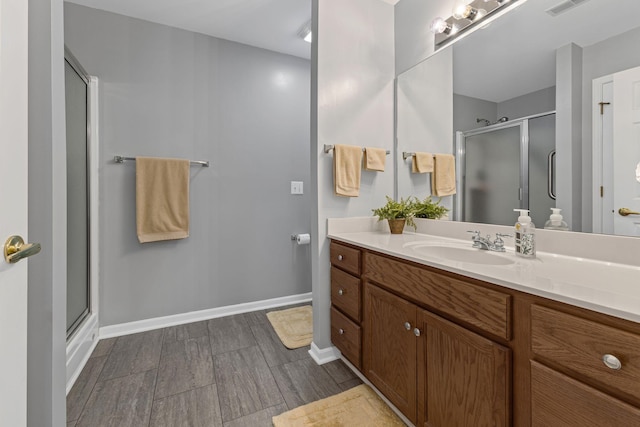 bathroom with walk in shower and vanity