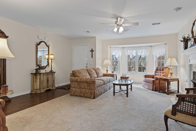 living room with hardwood / wood-style floors and ceiling fan