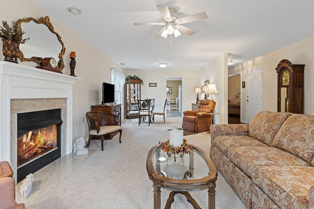 living room with ceiling fan and a fireplace