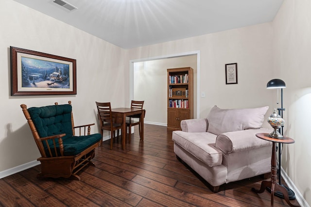 sitting room with dark wood-type flooring