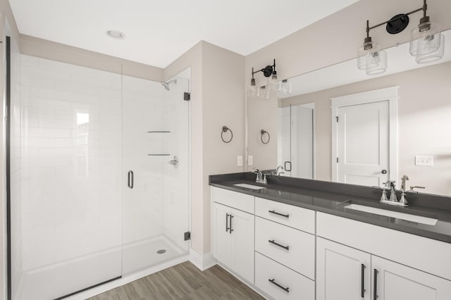 bathroom featuring vanity and an enclosed shower