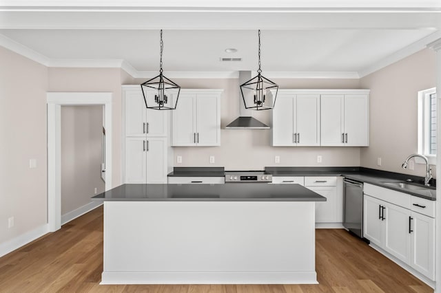 kitchen featuring appliances with stainless steel finishes, decorative light fixtures, sink, and white cabinets