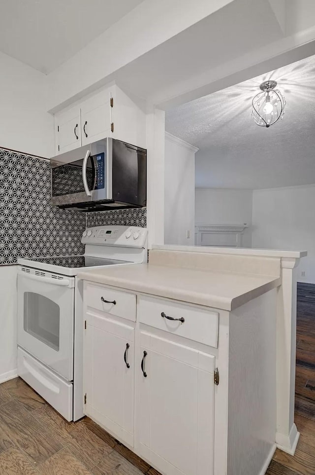 kitchen featuring white cabinetry, tasteful backsplash, kitchen peninsula, hardwood / wood-style flooring, and white range with electric cooktop