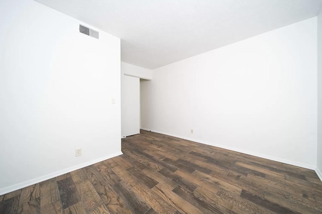 unfurnished room featuring dark wood-type flooring