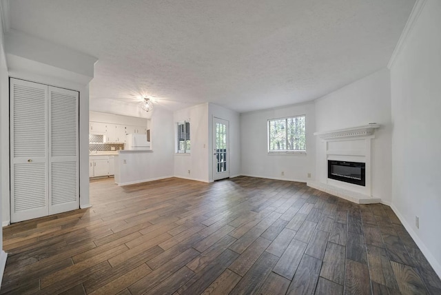 unfurnished living room with hardwood / wood-style floors and a textured ceiling