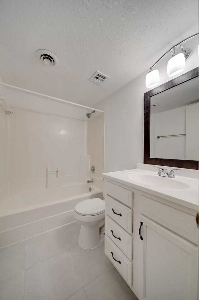 full bathroom featuring toilet,  shower combination, a textured ceiling, vanity, and tile patterned flooring