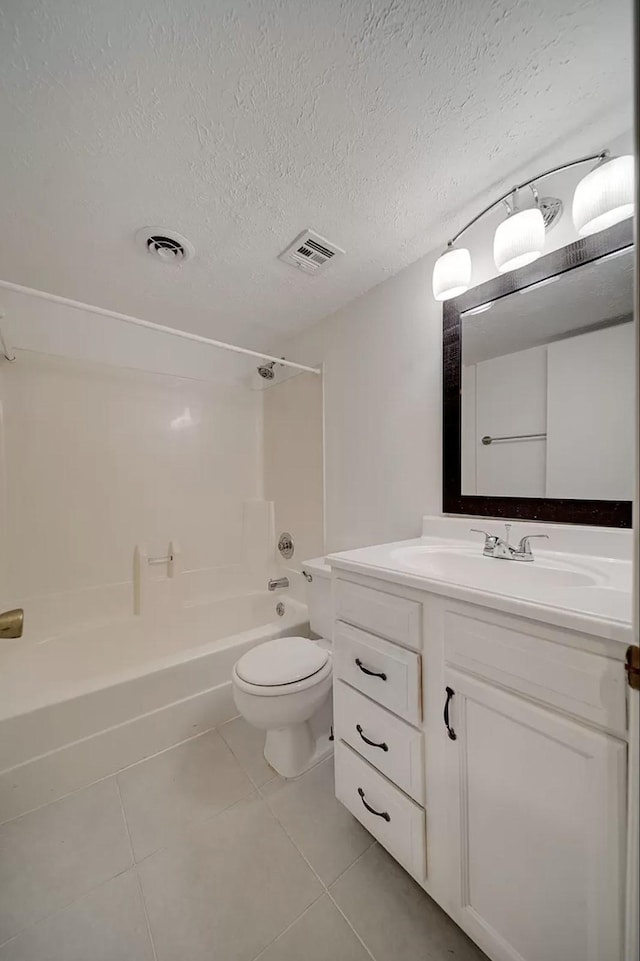 full bathroom with tile patterned floors, toilet, bathing tub / shower combination, a textured ceiling, and vanity