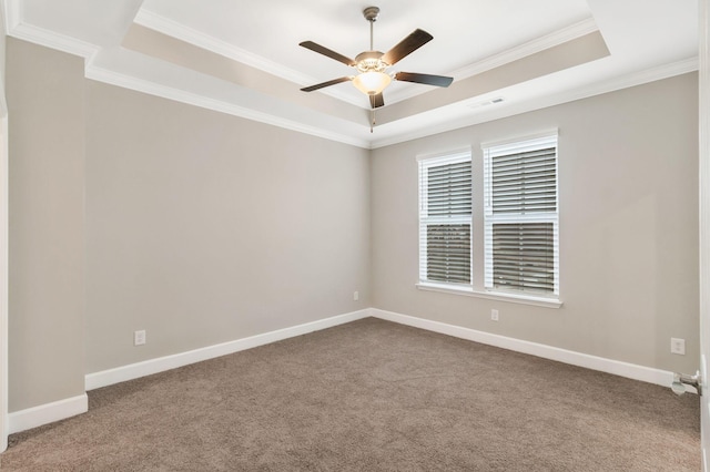 carpeted empty room featuring a raised ceiling, ornamental molding, and ceiling fan