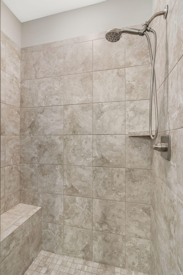 bathroom with a tile shower