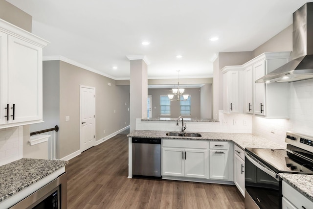 kitchen with wall chimney exhaust hood, stainless steel appliances, sink, and white cabinets