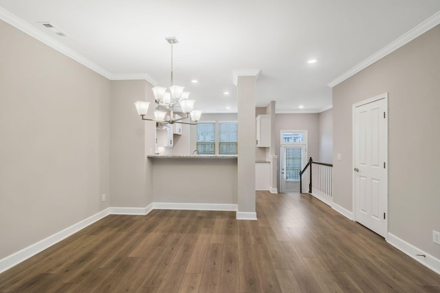 interior space featuring an inviting chandelier, ornamental molding, and dark hardwood / wood-style flooring