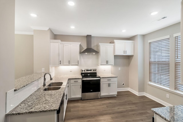 kitchen featuring sink, white cabinetry, stainless steel appliances, light stone countertops, and wall chimney exhaust hood