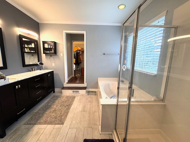 bathroom with vanity, a wealth of natural light, ornamental molding, and plus walk in shower