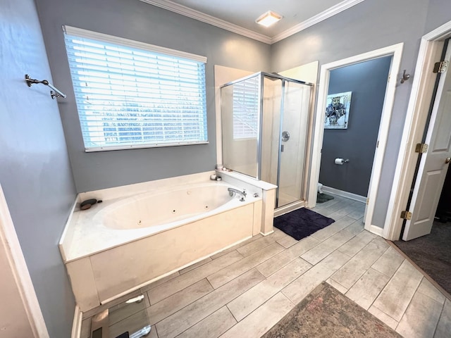 bathroom with crown molding and separate shower and tub