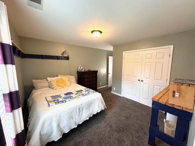 bedroom with dark carpet and a closet