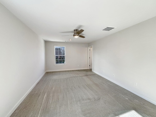 unfurnished room featuring light colored carpet and ceiling fan