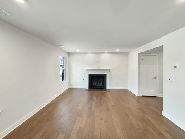 unfurnished living room featuring hardwood / wood-style flooring