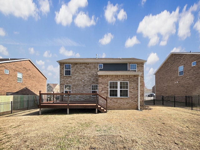 back of house with a wooden deck and a lawn