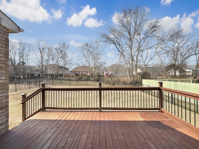 wooden terrace featuring a yard