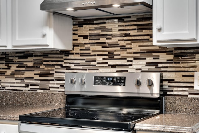 kitchen with white cabinetry, decorative backsplash, stainless steel electric stove, and range hood