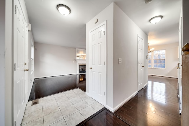 hall featuring a notable chandelier and light hardwood / wood-style flooring