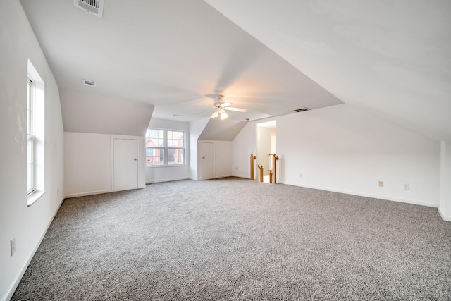 bonus room with ceiling fan, carpet flooring, and vaulted ceiling