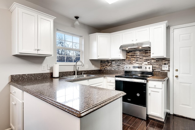 kitchen featuring backsplash, sink, stainless steel electric range, and white cabinets