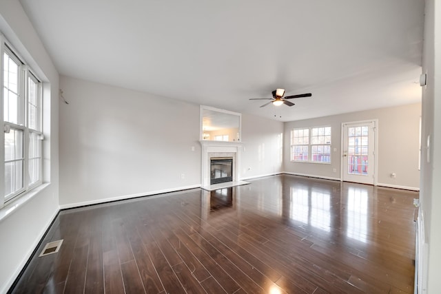 unfurnished living room featuring dark hardwood / wood-style floors and ceiling fan