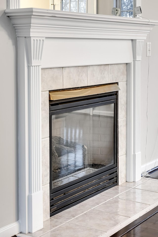 details featuring a tiled fireplace