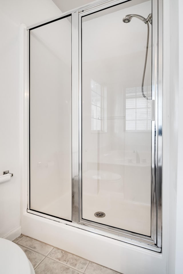 bathroom featuring tile patterned flooring and a shower with door