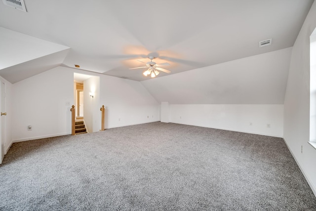 additional living space with lofted ceiling, carpet floors, and ceiling fan