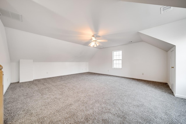 additional living space featuring ceiling fan, lofted ceiling, and carpet floors