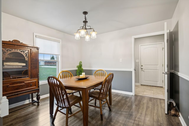 dining room featuring an inviting chandelier and dark hardwood / wood-style floors