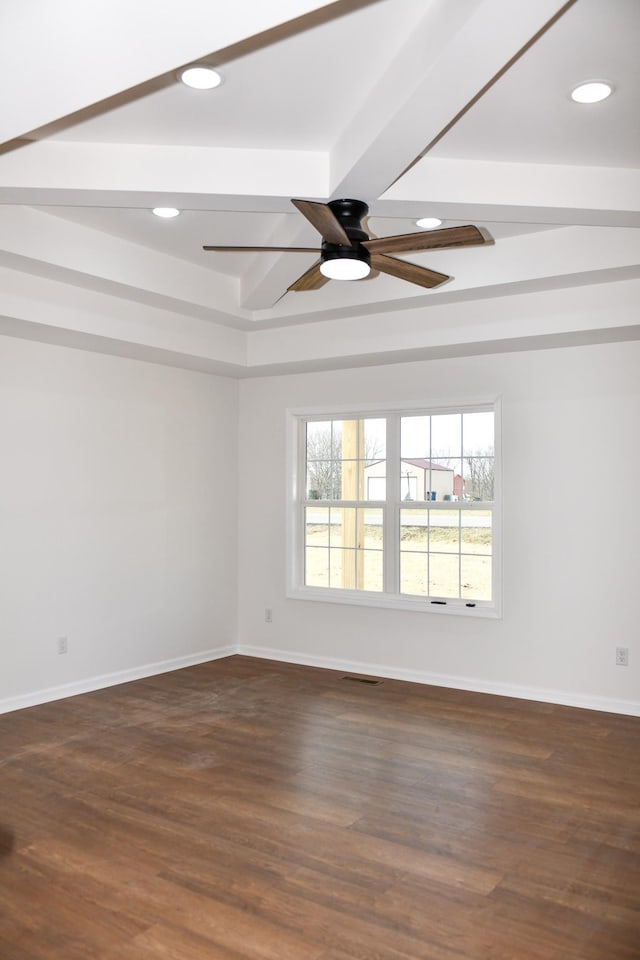 empty room featuring dark hardwood / wood-style flooring, ceiling fan, and beamed ceiling