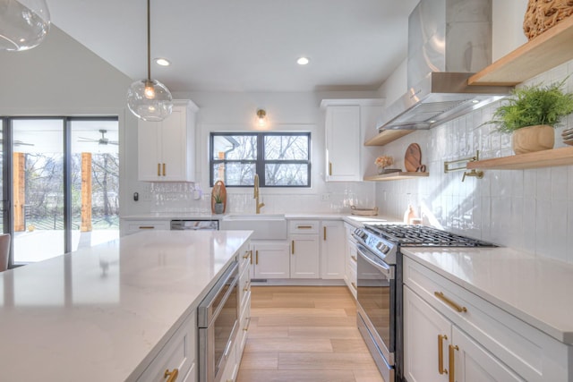 kitchen with sink, exhaust hood, white cabinets, and appliances with stainless steel finishes