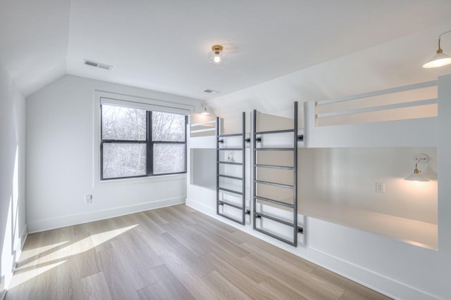 interior space featuring lofted ceiling and light wood-type flooring