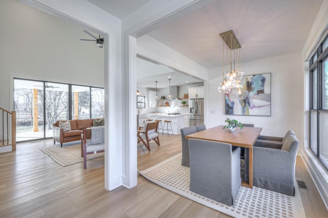 dining room featuring a notable chandelier and light hardwood / wood-style flooring