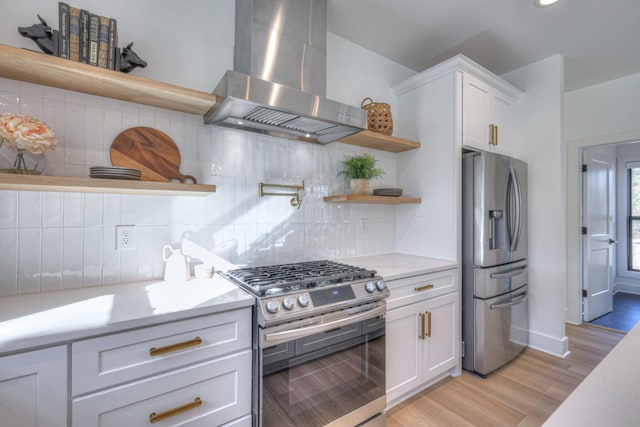 kitchen with white cabinetry, appliances with stainless steel finishes, extractor fan, and backsplash