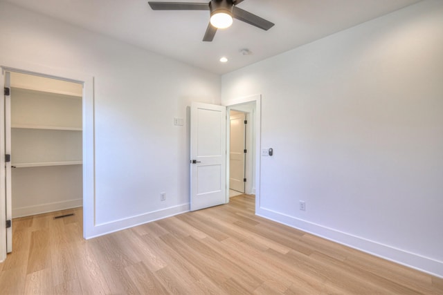 unfurnished bedroom with ceiling fan, a closet, and light hardwood / wood-style flooring